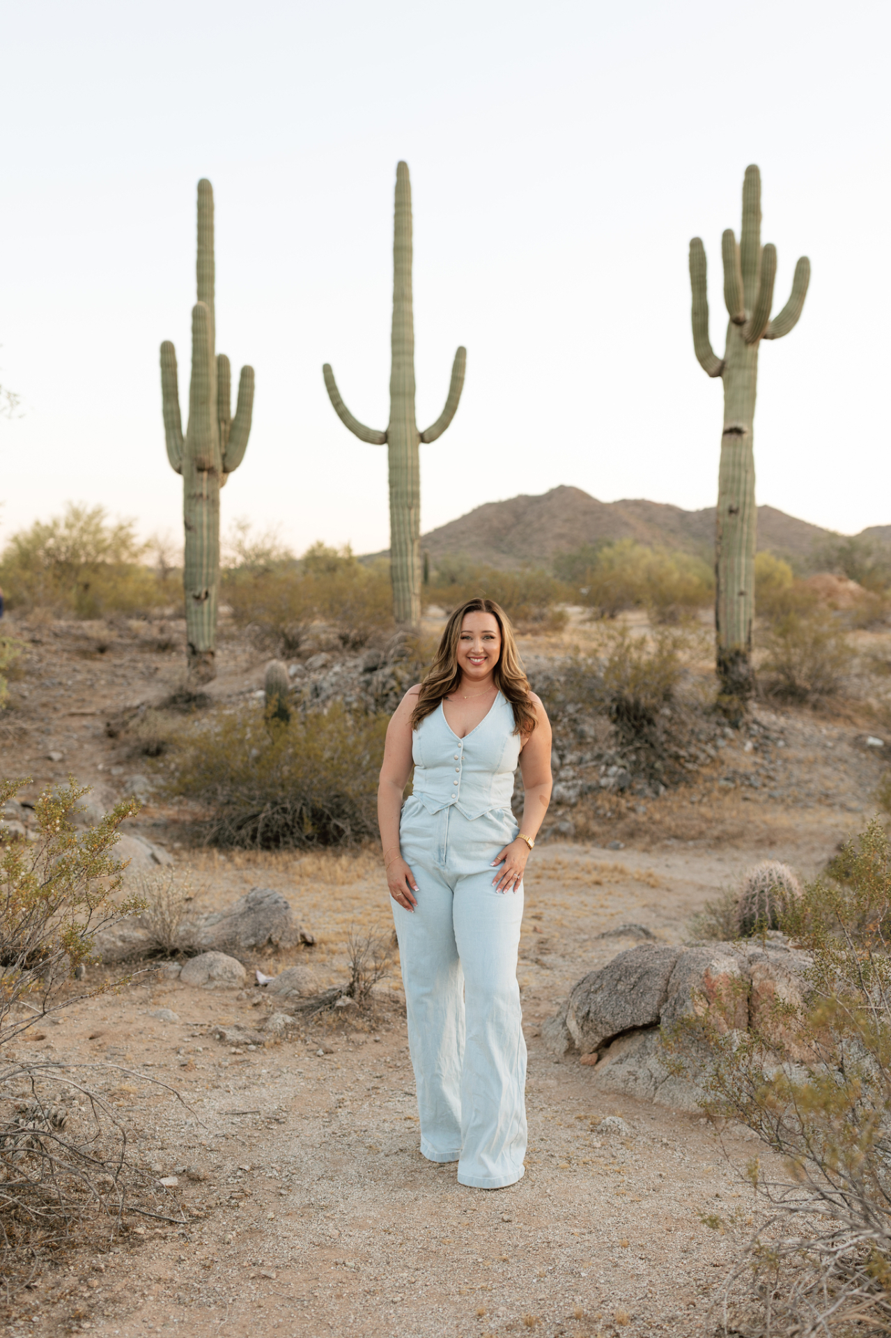 Haylee Duran in the Arizona desert at golden hour, framed by saguaros